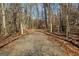 Gravel driveway leading to a wooded area with gate at 785 Seabolt Rd, Locust Grove, GA 30248