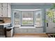 Kitchen features a built-in window seat overlooking backyard at 785 Seabolt Rd, Locust Grove, GA 30248
