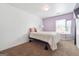 Bedroom with light bedding and purple accent wall at 5602 Waverly Park, Atlanta, GA 30349