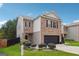 Two-story brick home with a black garage door and landscaped lawn at 5602 Waverly Park, Atlanta, GA 30349
