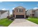 Two-story brick home with a black garage door and landscaped lawn at 5602 Waverly Park, Atlanta, GA 30349