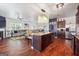 Open kitchen with granite island, stainless steel appliances, and hardwood floors at 5602 Waverly Park, Atlanta, GA 30349