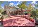 Spacious backyard with a large wood deck and a pergola, perfect for outdoor entertaining at 7300 Chattahoochee Bluff Dr, Sandy Springs, GA 30350