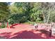 Large backyard with wooden deck, bench, and lush greenery at 7300 Chattahoochee Bluff Dr, Sandy Springs, GA 30350