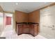 Convenient bar area with dark wood cabinets, gold fixtures, and decorative wall paint at 7300 Chattahoochee Bluff Dr, Sandy Springs, GA 30350