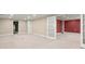Finished basement area with carpeted floors and multiple entryways and storage at 7300 Chattahoochee Bluff Dr, Sandy Springs, GA 30350