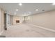 Expansive carpeted basement with a fireplace and recessed lighting at 7300 Chattahoochee Bluff Dr, Sandy Springs, GA 30350