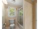 Bathroom featuring a toilet, glass shower and an exterior window at 7300 Chattahoochee Bluff Dr, Sandy Springs, GA 30350