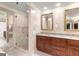 Stylish bathroom with a glass shower, double vanity, and elegant mirrors at 7300 Chattahoochee Bluff Dr, Sandy Springs, GA 30350