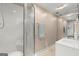 Bright bathroom features a glass shower, neutral walls, and a marble countertop at 7300 Chattahoochee Bluff Dr, Sandy Springs, GA 30350