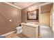 Bathroom featuring a vanity with a sink, a toilet, and a mirror at 7300 Chattahoochee Bluff Dr, Sandy Springs, GA 30350