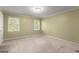 Bedroom with neutral walls, carpeted floors and light filled window at 7300 Chattahoochee Bluff Dr, Sandy Springs, GA 30350