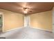 This cozy bedroom features neutral walls, a ceiling fan and a carpeted floor at 7300 Chattahoochee Bluff Dr, Sandy Springs, GA 30350