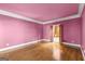 Bright bedroom featuring hardwood floors, crown molding, and a doorway to a closet at 7300 Chattahoochee Bluff Dr, Sandy Springs, GA 30350