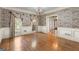 Large dining room with hardwood floors, window views, and elegant wall decor at 7300 Chattahoochee Bluff Dr, Sandy Springs, GA 30350