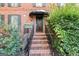 Charming home entrance with a brick staircase and well-maintained landscaping at 7300 Chattahoochee Bluff Dr, Sandy Springs, GA 30350