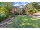 Beautiful two-story brick home featuring a well-manicured lawn and garden at 7300 Chattahoochee Bluff Dr, Sandy Springs, GA 30350
