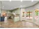 This kitchen features custom cabinets with stone countertops and a breakfast bar with backyard views at 7300 Chattahoochee Bluff Dr, Sandy Springs, GA 30350