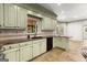 This kitchen features custom cabinets, tile backsplash, stone countertops, and stainless appliances at 7300 Chattahoochee Bluff Dr, Sandy Springs, GA 30350