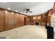 Large living room featuring custom wood paneling, built-in shelving, and a fireplace at 7300 Chattahoochee Bluff Dr, Sandy Springs, GA 30350