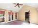 Sunroom featuring a ceiling fan, multiple windows, and a door to a room inside the home at 7300 Chattahoochee Bluff Dr, Sandy Springs, GA 30350