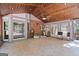 Bright sunroom with tile floors, wood paneled ceiling, and multiple glass doors and windows at 7300 Chattahoochee Bluff Dr, Sandy Springs, GA 30350