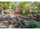 Backyard with serene water feature and multilevel deck with pergola at 7300 Chattahoochee Bluff Dr, Sandy Springs, GA 30350