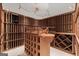 Climate-controlled wine cellar with custom wooden racks and display shelves at 7300 Chattahoochee Bluff Dr, Sandy Springs, GA 30350
