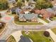 Aerial shot of a charming brick home in a well-maintained neighborhood with mature trees at 1115 Oakpark Drive Dr, Mcdonough, GA 30253
