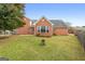 This home features a brick back exterior with patio area and a well-maintained lawn at 1115 Oakpark Drive Dr, Mcdonough, GA 30253