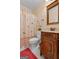 Bathroom featuring bird-themed shower curtain, wood vanity, and toilet at 1115 Oakpark Drive Dr, Mcdonough, GA 30253