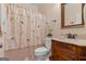 Bathroom featuring bird-themed shower curtain, wood vanity, and toilet at 1115 Oakpark Drive Dr, Mcdonough, GA 30253