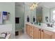 Bathroom area featuring a double sink vanity, soaking tub, and neutral tile at 1115 Oakpark Drive Dr, Mcdonough, GA 30253
