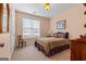 Cozy bedroom with a large window, a comfortable bed, and a chair at 1115 Oakpark Drive Dr, Mcdonough, GA 30253