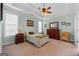 Bedroom featuring tray ceiling, ceiling fan, and neutral tones at 1115 Oakpark Drive Dr, Mcdonough, GA 30253