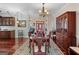Dining room area with hardwood floors, classic chandelier, and built-in china cabinet at 1115 Oakpark Drive Dr, Mcdonough, GA 30253