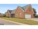 Beautiful brick home with attached two-car garage and mature landscaping surrounding at 1115 Oakpark Drive Dr, Mcdonough, GA 30253