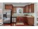 Kitchen area showcasing stainless steel appliances, wood cabinets, and a practical layout at 1115 Oakpark Drive Dr, Mcdonough, GA 30253
