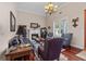 Comfortable living room with plush seating, a fireplace, and gleaming hardwood floors at 1115 Oakpark Drive Dr, Mcdonough, GA 30253