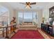 Bright living room with large windows, ceiling fan, and comfortable seating area at 1115 Oakpark Drive Dr, Mcdonough, GA 30253