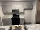 Modern kitchen featuring gray cabinets, granite countertops, and black appliances at 3204 Fairington Village Dr, Lithonia, GA 30038