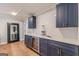 Basement wet bar with dark cabinetry and wine cooler at 2803 Mathews Se St, Smyrna, GA 30080