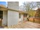 View of a wooden back deck with stairs, connected to a white brick house with several windows at 105 Tranquility Dr, Villa Rica, GA 30180