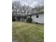 Spacious backyard with mature trees, showcasing the home's peaceful setting and outdoor potential at 105 Tranquility Dr, Villa Rica, GA 30180