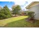 Backyard view with green lawn, mature trees, and a partial view of the house at 105 Tranquility Dr, Villa Rica, GA 30180