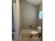 Compact bathroom with a toilet and window; functional and ready for upgrades at 105 Tranquility Dr, Villa Rica, GA 30180