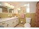 Bathroom with a retro design, including yellow tiles and a floral shower curtain at 105 Tranquility Dr, Villa Rica, GA 30180