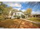 Exterior of the house featuring a side deck, mature trees and a driveway with parked vehicles at 105 Tranquility Dr, Villa Rica, GA 30180