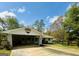 Bright exterior view showcasing the home's carport and neat landscaping against a blue sky at 105 Tranquility Dr, Villa Rica, GA 30180