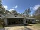 Front exterior with carport featuring brick support and neutral paint, complemented by well-maintained grounds at 105 Tranquility Dr, Villa Rica, GA 30180